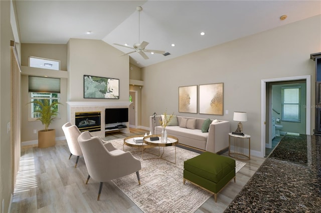 living room with high vaulted ceiling, light hardwood / wood-style floors, and ceiling fan