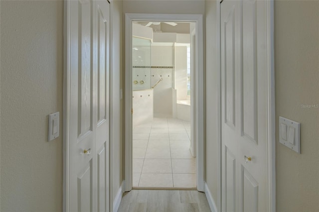 hall featuring light tile flooring