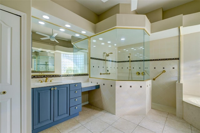 bathroom featuring ceiling fan, tile walls, tile floors, shower with separate bathtub, and vanity with extensive cabinet space