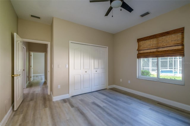 unfurnished bedroom with a closet, ceiling fan, and light wood-type flooring