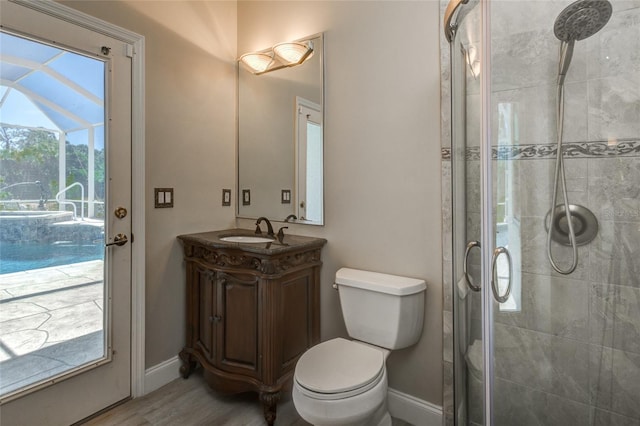 bathroom with toilet, large vanity, walk in shower, and wood-type flooring