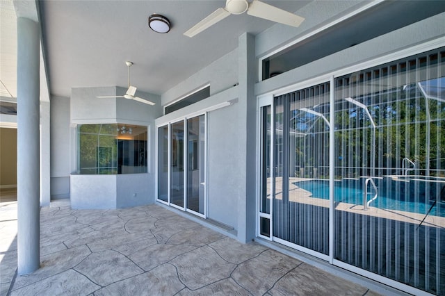 view of patio / terrace featuring a fenced in pool and ceiling fan