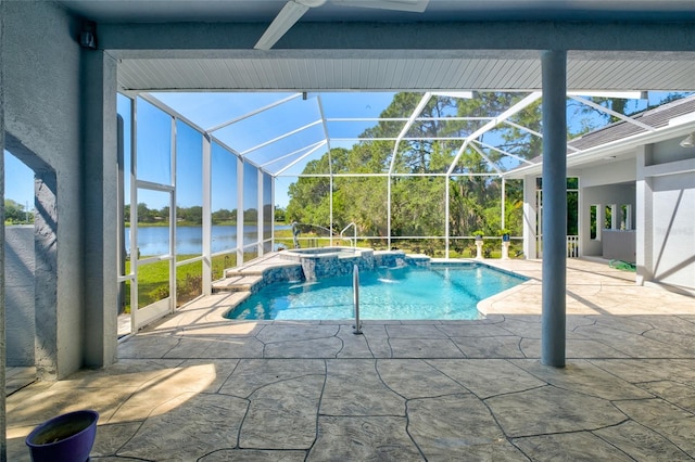 view of swimming pool with an in ground hot tub, glass enclosure, a patio, and a water view