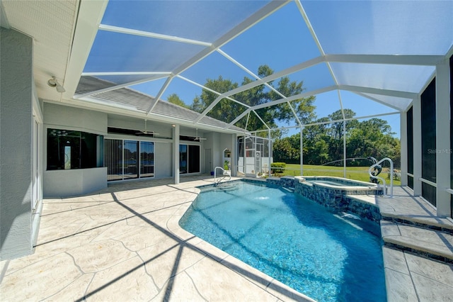 view of swimming pool featuring a patio, a lanai, pool water feature, and an in ground hot tub