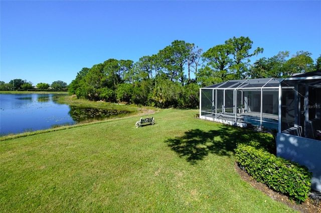 view of yard with a water view and a lanai