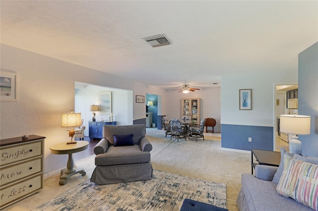 carpeted living room featuring ceiling fan