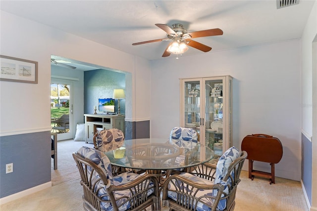 carpeted dining space featuring ceiling fan