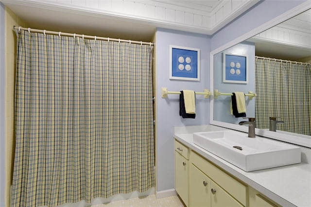 bathroom featuring tile patterned flooring, a shower with curtain, and vanity