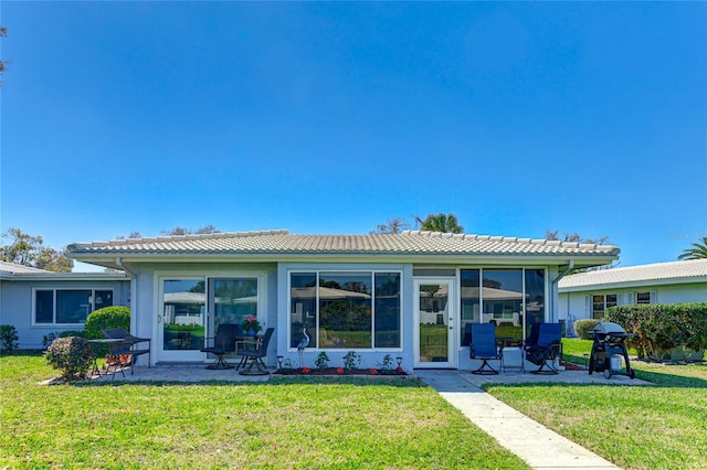 rear view of property with a lawn