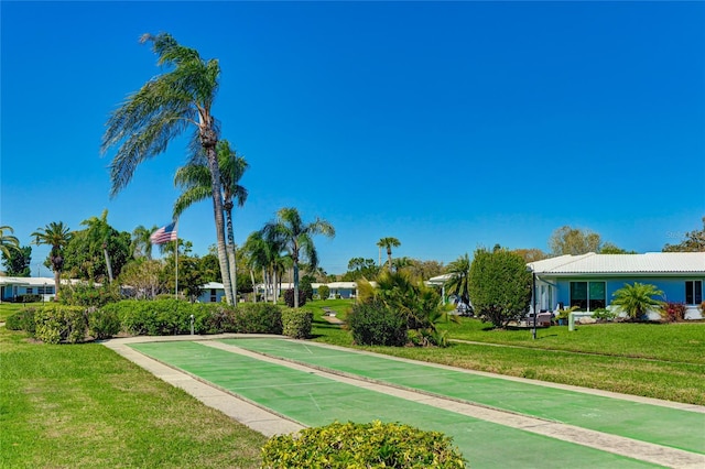 view of property's community with a lawn