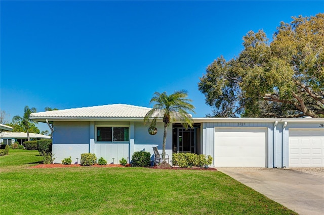 ranch-style house with a front yard and a garage