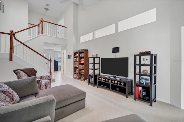 living room with a high ceiling and light colored carpet