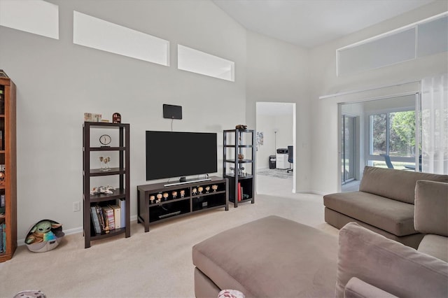 carpeted living room featuring a high ceiling