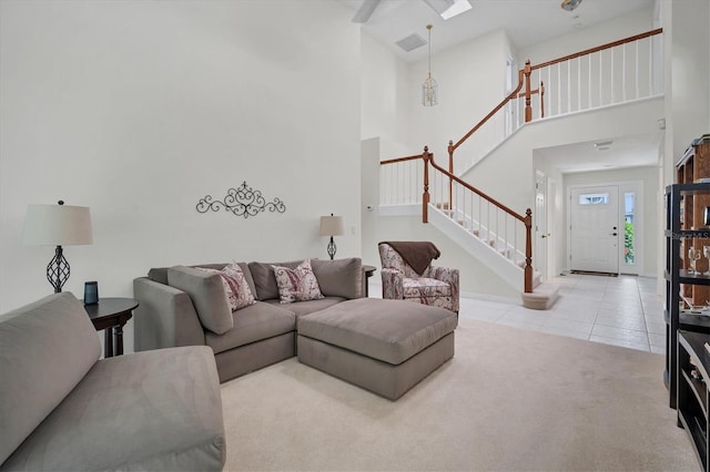 carpeted living room with a high ceiling