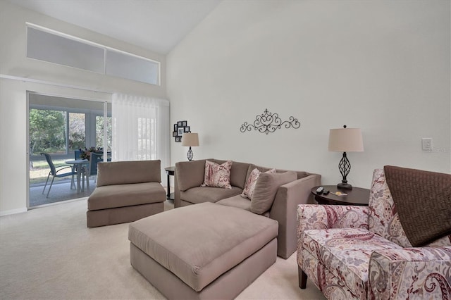 carpeted living room featuring high vaulted ceiling