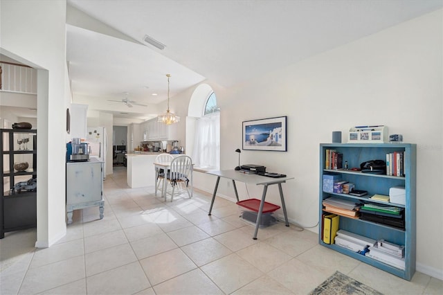 office space featuring light tile floors, lofted ceiling, and ceiling fan with notable chandelier