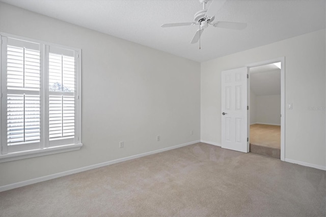 unfurnished room featuring light colored carpet and ceiling fan