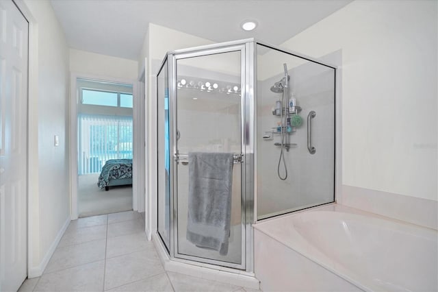 bathroom with separate shower and tub and tile flooring