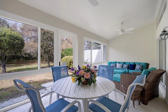 sunroom / solarium with plenty of natural light, ceiling fan, and lofted ceiling