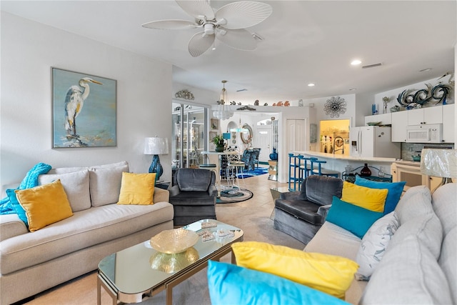 living area with a ceiling fan, recessed lighting, and light carpet