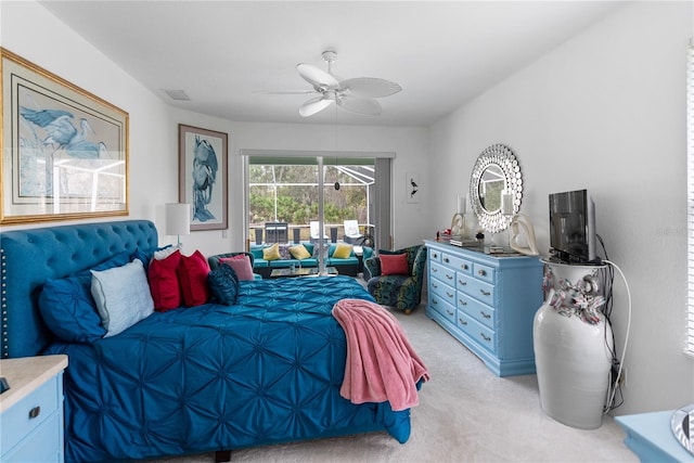 bedroom featuring light carpet, access to exterior, ceiling fan, and visible vents