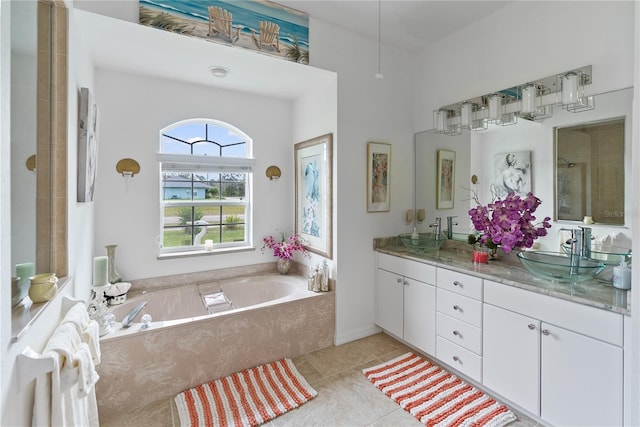 full bathroom featuring double vanity, a garden tub, tile patterned flooring, and a sink