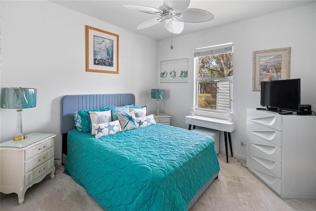 bedroom with light carpet and a ceiling fan