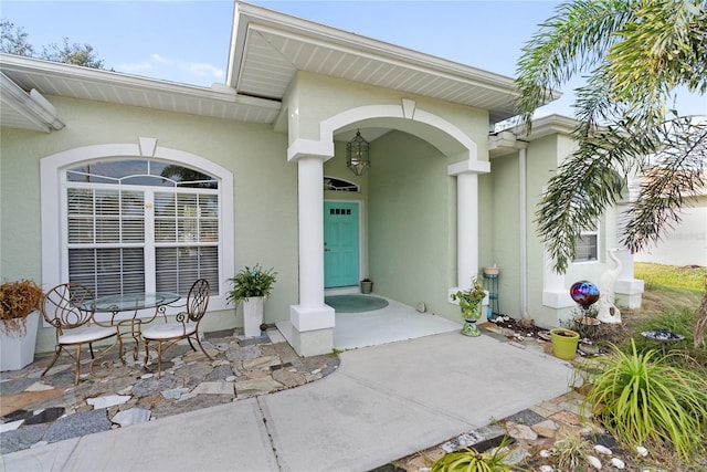 property entrance with stucco siding