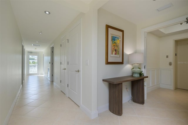 corridor featuring light tile patterned flooring