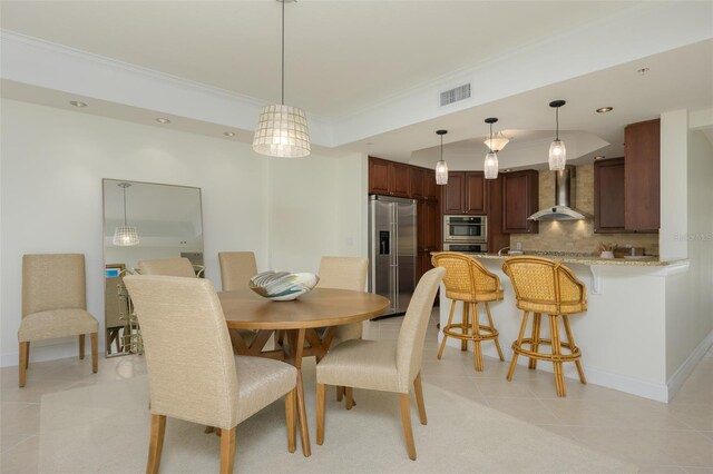 dining room featuring light tile patterned floors and ornamental molding