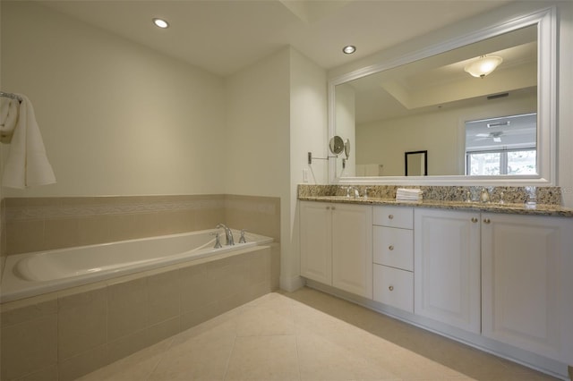 bathroom with vanity, tile patterned flooring, and tiled bath