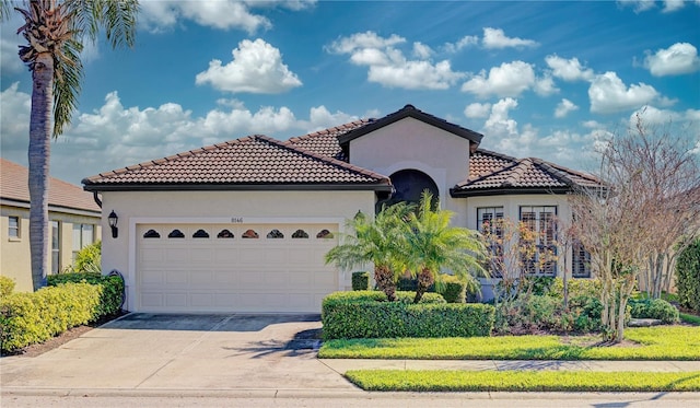 mediterranean / spanish-style home featuring a garage