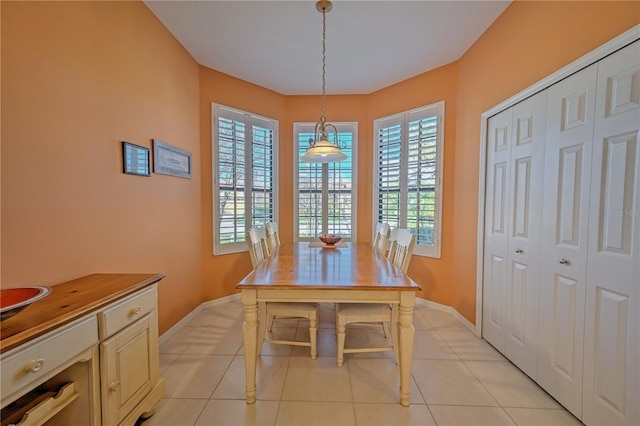 dining area featuring light tile floors