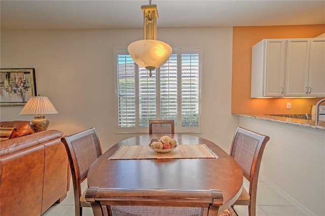 dining space featuring light tile floors