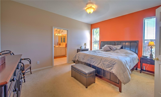 carpeted bedroom featuring ensuite bath and ceiling fan