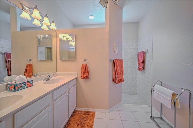 bathroom featuring a textured ceiling, tile floors, double vanity, and a chandelier