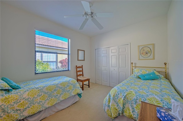 carpeted bedroom with a closet and ceiling fan