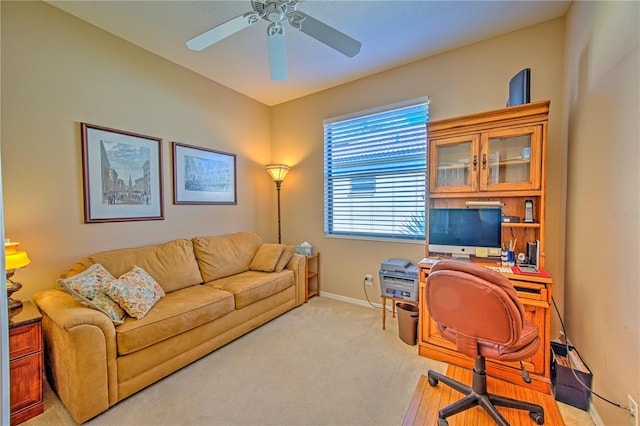 carpeted office featuring ceiling fan