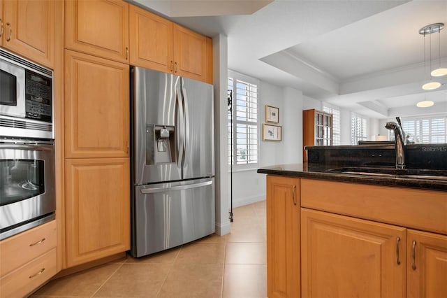 kitchen featuring sink, light tile patterned floors, stainless steel appliances, a wealth of natural light, and a raised ceiling