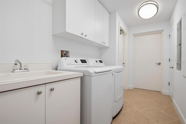 laundry area featuring cabinets, sink, washer and dryer, and light tile patterned floors