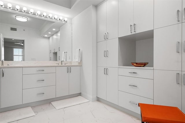 bathroom with vanity and crown molding