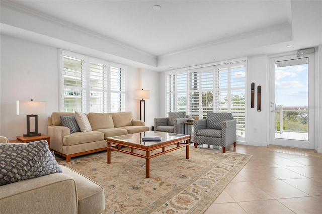 tiled living room featuring crown molding and a raised ceiling