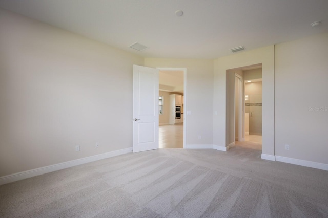 unfurnished bedroom with light colored carpet