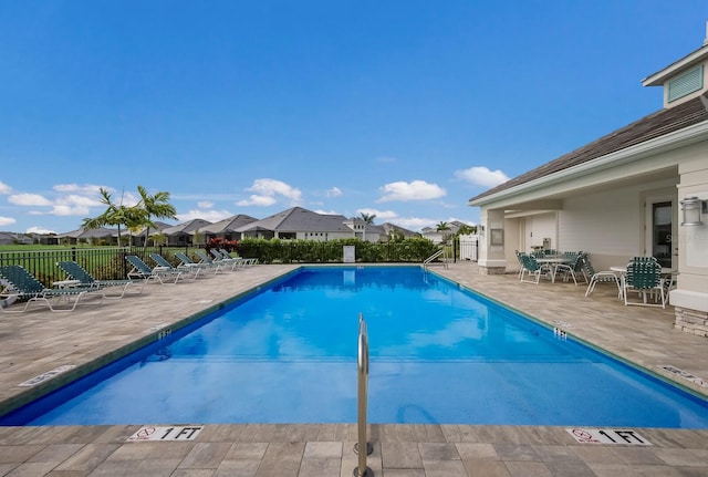 view of swimming pool with a patio