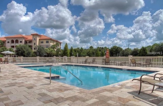 view of swimming pool featuring a patio area