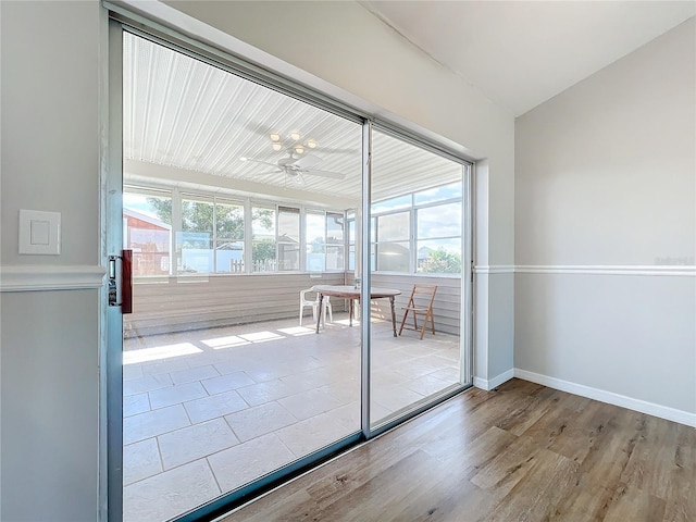 entryway with ceiling fan and light hardwood / wood-style flooring