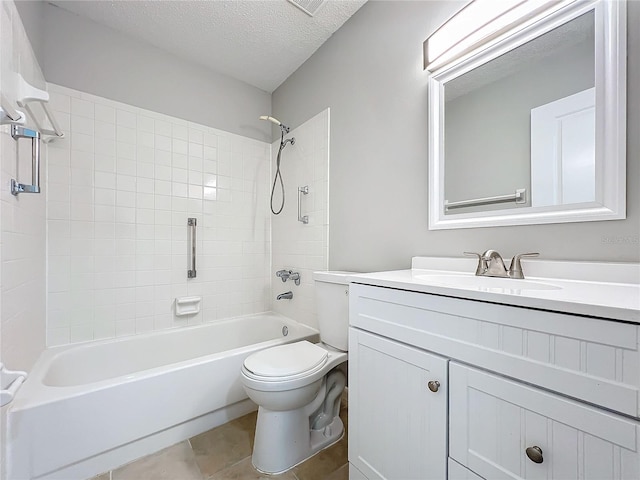 full bathroom with tiled shower / bath combo, toilet, vanity with extensive cabinet space, tile flooring, and a textured ceiling