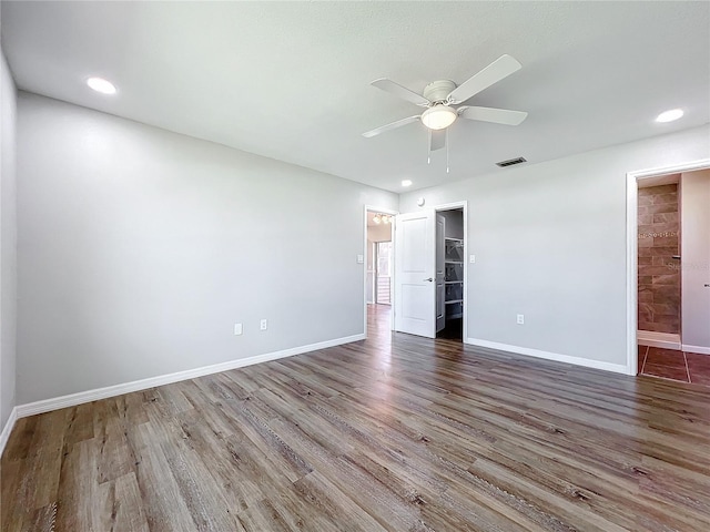 empty room featuring ceiling fan and dark hardwood / wood-style floors