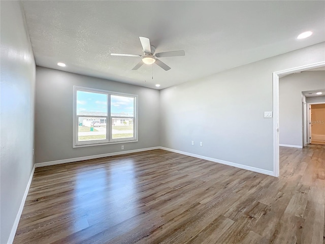 unfurnished room with hardwood / wood-style floors, a textured ceiling, and ceiling fan