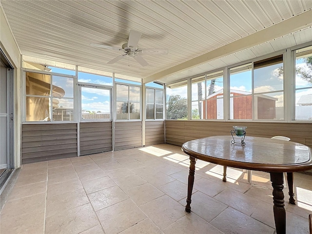 unfurnished sunroom featuring ceiling fan